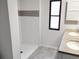 Updated bathroom with double vanity and tiled shower at 102 Jackson Dr, Firestone, CO 80520