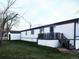 Mobile home exterior with detached garage and grassy yard at 102 Jackson Dr, Firestone, CO 80520