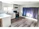 Bright kitchen with white cabinets and teal stove at 102 Jackson Dr, Firestone, CO 80520