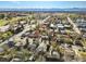 A picturesque aerial view of a residential area with mature trees and distant mountain vistas at 3778 S Hooker St, Englewood, CO 80110