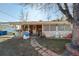 Single-story home with a covered back patio, a brick walkway, and a green lawn presents an opportunity for customization at 3778 S Hooker St, Englewood, CO 80110