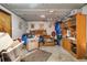 Unfinished basement featuring bare concrete floors, paneled walls, drop ceiling, and vintage cabinets in need of an overhaul at 3778 S Hooker St, Englewood, CO 80110