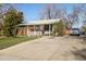 Charming brick home features a covered front porch and long driveway at 3778 S Hooker St, Englewood, CO 80110