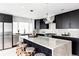 Modern kitchen island with granite countertop and black cabinetry at 5355 E Iowa Ave, Denver, CO 80222