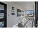 Charming front porch with seating, stylish black door, and ample natural light at 3285 S Emerson St, Englewood, CO 80113