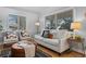 Bright living room with hardwood floors, neutral furniture, and large windows at 3285 S Emerson St, Englewood, CO 80113