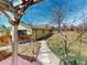 Well-maintained backyard featuring a stone walkway, mature trees, and a charming yellow shed at 4487 S Alkire St, Morrison, CO 80465