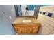 The bathroom vanity features a natural wood finish, granite countertop, and decorative hardware at 4487 S Alkire St, Morrison, CO 80465