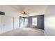 A cozy carpeted bedroom with a ceiling fan, two windows, and a closet for storage at 4487 S Alkire St, Morrison, CO 80465