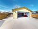 Detached garage with open door, lighting, workbench, and storage cabinets and a red sofa at 4487 S Alkire St, Morrison, CO 80465