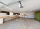 Spacious empty garage with painted walls, cabinets, lighting, workbenches and cement floors at 4487 S Alkire St, Morrison, CO 80465