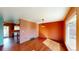 Brightly painted living room with wood floors, a dining area, and an adjacent kitchen space at 4487 S Alkire St, Morrison, CO 80465