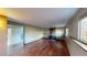 Spacious living room featuring hardwood flooring, natural light, and a charming wood-burning stove at 4487 S Alkire St, Morrison, CO 80465