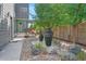 Landscaped backyard with a relaxing water feature and stone pathway at 4937 Tamarac St, Denver, CO 80238