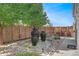 Landscaped backyard with water features, stone pathways, and mature trees at 4937 Tamarac St, Denver, CO 80238