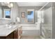 Clean bathroom with soaking tub, walk-in shower, and double vanity at 4937 Tamarac St, Denver, CO 80238