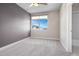 Cozy bedroom with gray accent wall and carpeted floor at 4937 Tamarac St, Denver, CO 80238