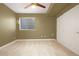 Bright bedroom with carpeted floor, window with blinds, and ample closet space at 4937 Tamarac St, Denver, CO 80238