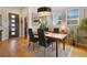 Modern dining area with wood table and black chairs at 4937 Tamarac St, Denver, CO 80238