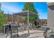 Outdoor patio with modern pergola, grill, and seating area, perfect for entertaining at 4937 Tamarac St, Denver, CO 80238