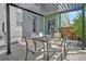 Covered patio with seating area, modern pergola, and built in grill at 4937 Tamarac St, Denver, CO 80238