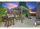 Evening view of patio with pergola, grill, and seating area at 4937 Tamarac St, Denver, CO 80238