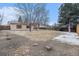 Large backyard with a fence, mature trees, and a patio area; perfect for outdoor activities at 6047 Vivian Ct, Arvada, CO 80004