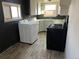 Efficient kitchen with a washing machine and gas range at 2915 W 4Th Ave, Denver, CO 80219