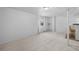 Spacious basement with window, neutral carpeting, and access to the bar area at 8761 Cloverleaf Cir, Parker, CO 80134