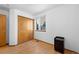 Small bedroom featuring natural light and closet with sliding doors at 8761 Cloverleaf Cir, Parker, CO 80134