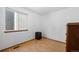 Simple bedroom offers a window, laminate flooring and a side table at 8761 Cloverleaf Cir, Parker, CO 80134
