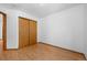 Cozy bedroom featuring wood floors and a closet with sliding doors at 8761 Cloverleaf Cir, Parker, CO 80134