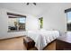 Comfortable bedroom featuring natural light from two windows and light colored walls at 8761 Cloverleaf Cir, Parker, CO 80134