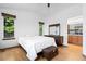 Well-lit bedroom featuring natural light, hardwood floors, and spacious closet at 8761 Cloverleaf Cir, Parker, CO 80134