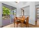 Sunny dining area showcases wood floors and sliding glass door to the deck at 8761 Cloverleaf Cir, Parker, CO 80134