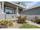 Charming home featuring a lovely front porch, well-maintained lawn, and vibrant floral landscaping at 8761 Cloverleaf Cir, Parker, CO 80134