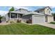 Charming home with a well-manicured front yard, colorful flowers, and an attached two-car garage at 8761 Cloverleaf Cir, Parker, CO 80134