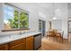 Bright kitchen features a double basin sink, wood cabinets and stainless steel dishwasher at 8761 Cloverleaf Cir, Parker, CO 80134