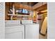 Functional laundry room with washer and dryer, and shelving units at 8761 Cloverleaf Cir, Parker, CO 80134