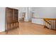 Spacious living room featuring hardwood floors, a china cabinet, and staircase at 8761 Cloverleaf Cir, Parker, CO 80134