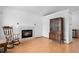 Cozy living room with a fireplace, hardwood floors, and a classic china cabinet at 8761 Cloverleaf Cir, Parker, CO 80134