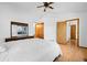 Spacious main bedroom with white walls, wood floors, ceiling fan and ensuite at 8761 Cloverleaf Cir, Parker, CO 80134
