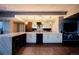 Contemporary kitchen with a marble backsplash, wine cooler, pendant lights, and breakfast bar seating at 2001 Lincoln St # 2923, Denver, CO 80202