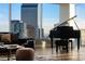 Elegant living room featuring grand piano and stunning views at 2001 Lincoln St # 2923, Denver, CO 80202