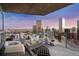 Spacious balcony with lounge seating and fire pit showcases panoramic views of the city skyline at 2001 Lincoln St # 2923, Denver, CO 80202