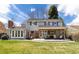 Spacious backyard with patio, outdoor seating, and green grass at 6964 S Olive Way, Centennial, CO 80112