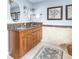 Bright bathroom featuring double sinks, granite countertop, and tiled floors at 6964 S Olive Way, Centennial, CO 80112