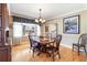 Formal dining room with wooden table, hardwood floors, and a chandelier at 6964 S Olive Way, Centennial, CO 80112