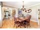 Bright dining room with hardwood floors, chandelier, and staircase at 6964 S Olive Way, Centennial, CO 80112
