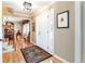 Welcoming foyer with hardwood floors, a colorful rug, and staircase view of dining room at 6964 S Olive Way, Centennial, CO 80112